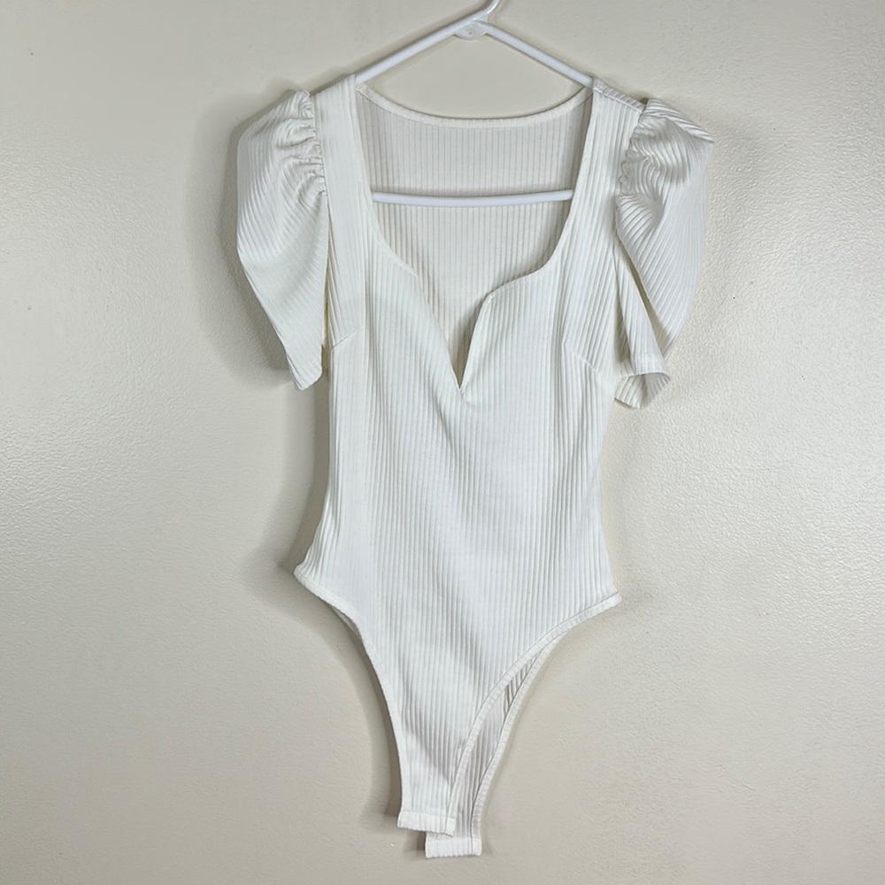 Deep V short sleeve, white bodysuit #2 long sleeve, red thong, bodysuit.